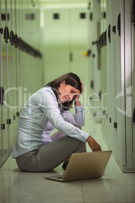 Stressed technician using laptop