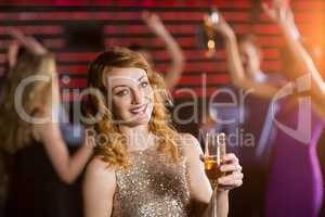 Portrait of young woman holding a glass of champagne