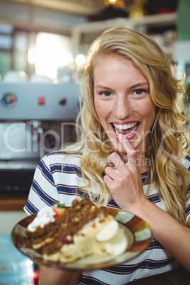 Woman holding a plate of desserts