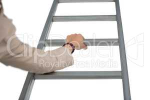Businesswoman holding ladder