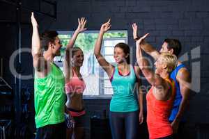 Smiling athletes giving high-five