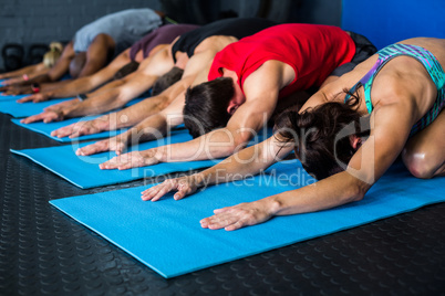 Athlete friends stretching while kneeling