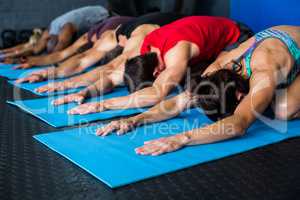 Athlete friends stretching while kneeling