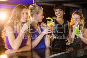 Friends having glass of cocktail in bar