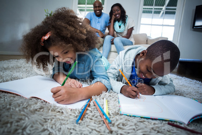 Children doing their homework with parents in background