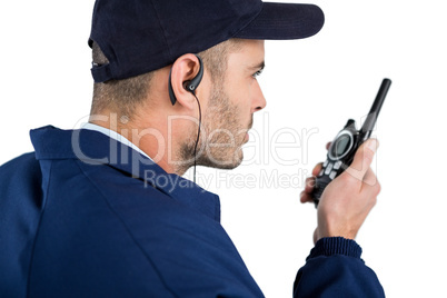 Close-up of security officer talking on walkie-talkie
