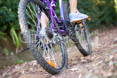 Female cyclist cycling in countryside