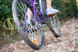 Female cyclist cycling in countryside