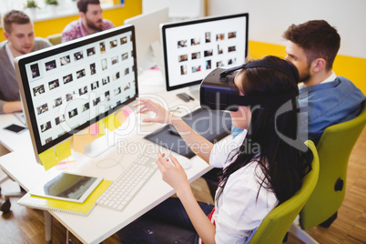 High angle view of executive using augmented reality headset at creative office