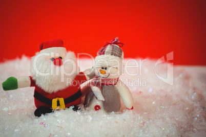 Santa claus and snowman on snow