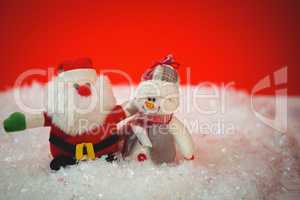 Santa claus and snowman on snow