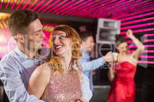 Cute couple dancing together on dance floor