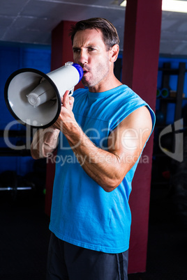 Fitness instructor shouting through megaphone