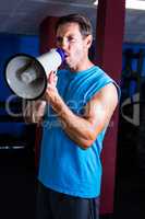 Fitness instructor shouting through megaphone