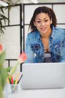 Portrait of businesswoman using laptop