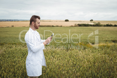 Agronomist using digital tablet in the field