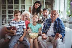 Unhappy multi-generation family watching soccer match on television in living room