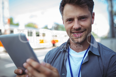 Handsome business executive using digital tablet