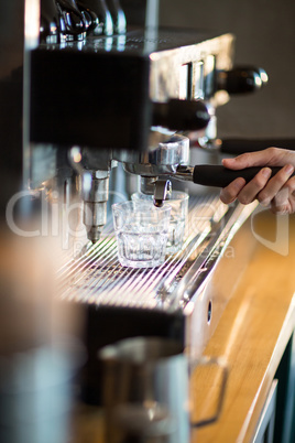 Waitress making cup of coffee