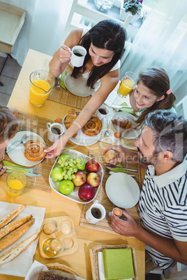 Happy family having breakfast at home