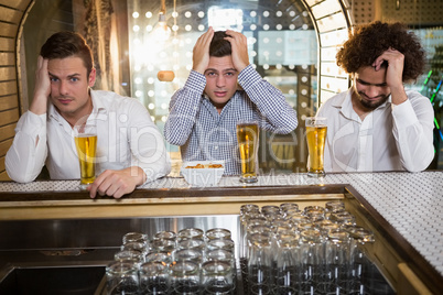 Group of men watching television in bar