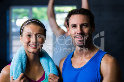 Confident male and female athlete in gym