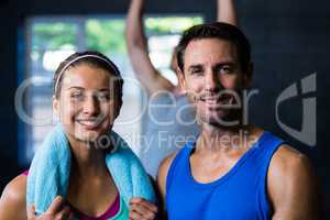 Confident male and female athlete in gym