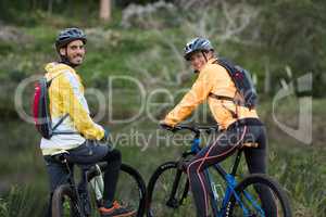 Biker couple with mountain bike in countryside