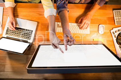 Businesswoman and colleague working on at their desk