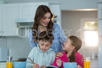 Mother with son and daughter having breakfast