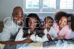 Happy family lying on bed