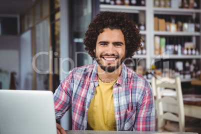 Portrait of happy man with laptop