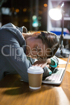 Businesswoman sleeping while working in office