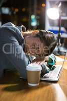 Businesswoman sleeping while working in office