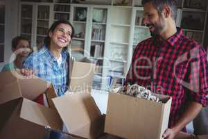 Happy family unpacking cartons together