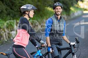 Biker couple with mountain bike on the road