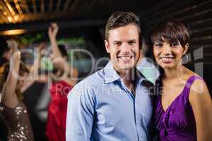 Cute couple standing together in bar