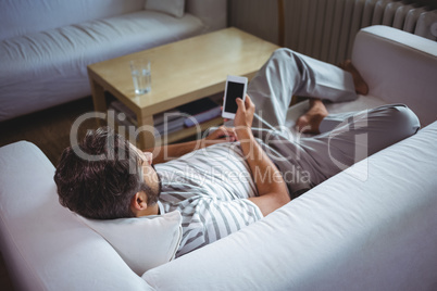 Man using his mobile phone in living room