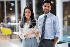 Businesswoman and businessman with mobile phone