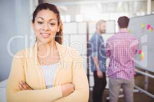 Portrait of confident young businesswoman standing at creative office