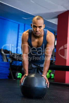 Portrait of serious athlete with fitness ball