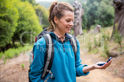 Female hiker looking at compass