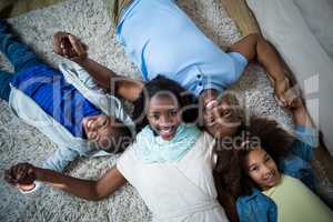 Portrait of family lying on the floor