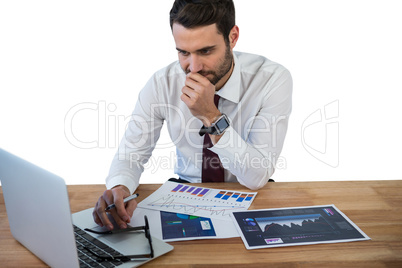 Businessman working on laptop in office