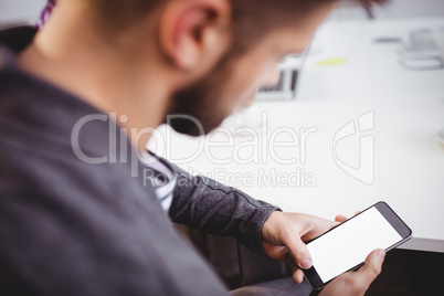 Businessman using mobile phone in meeting at creative office