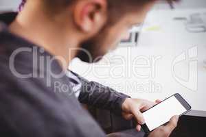 Businessman using mobile phone in meeting at creative office