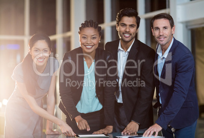 Group of businesspeople discussing together over digital tablet