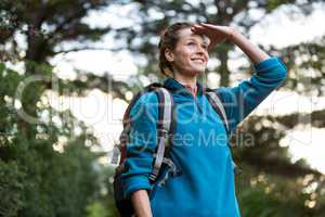 Female hiker shielding her eyes