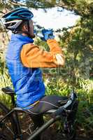 Male mountain biker drinking water