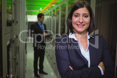 Portrait of female technician standing with arms crossed